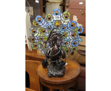 A Tiffany style lamp in the form of a peacock 