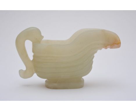 A small Chinese jade carving in the form of a jug in russet and green colour