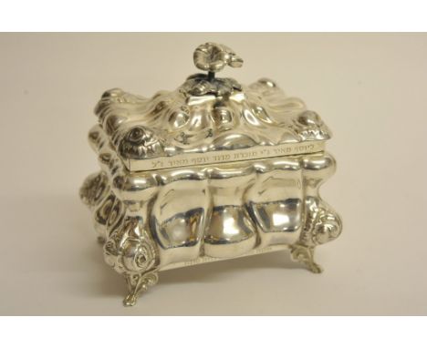 A quality sterling silver tea caddy of ornate bombe form with cast flower finial engraved with Hebrew script and marked to th