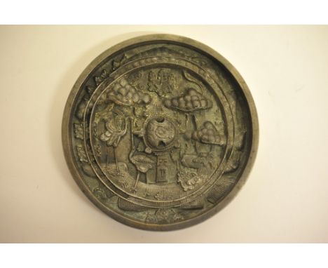 A bronze, Chinese round mirror, having carved ornate reverse showing a turtle and birds