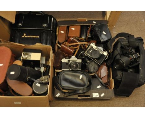 A large collection of various cameras, lenses and binoculars including a video camera and a Praktica SLR