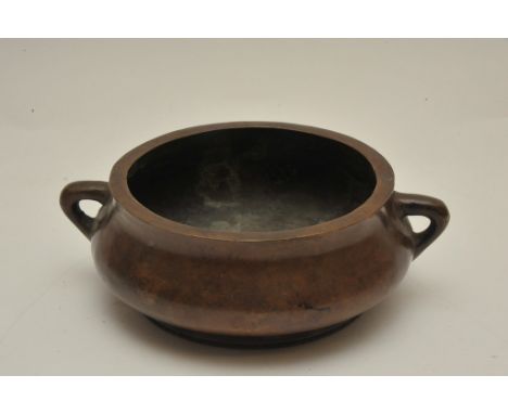 A Chinese twin handled bronze censer having two character Xuande mark. Diameter (handle to handle): 18.5cm approximately
