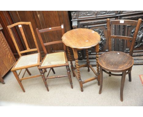 A small collection of furniture comprising a small oak open shelf unit, an oak table, a bentwood chair and one other chair