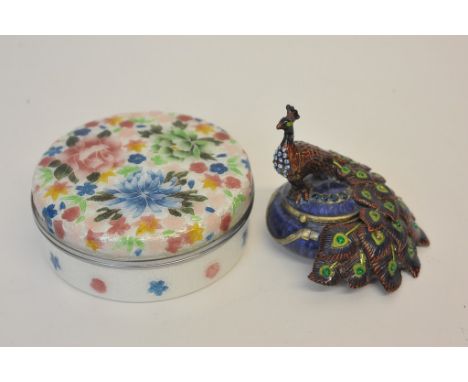 An attractive enamelled circular shallow trinket box and cover profusely decorated with multi-coloured flowers and leaves and
