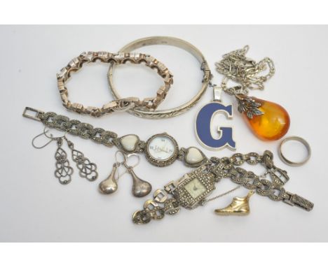 A collection of silver and white metal jewellery comprising a silver bangle, a silver bracelet, two marcasite set silver ladi