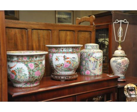 Four Chinese Famille Rose planters, a covered canister pot and a lidded vase converted into a lamp