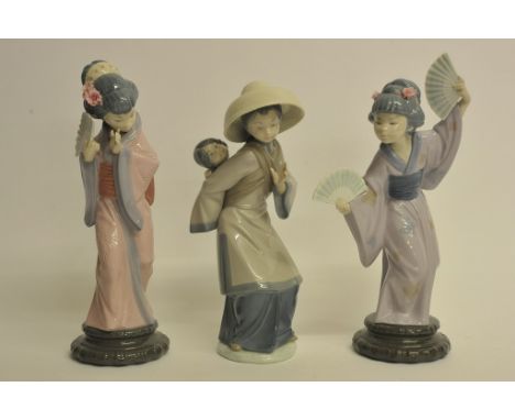 A collection of three Lladro Japanese figures.