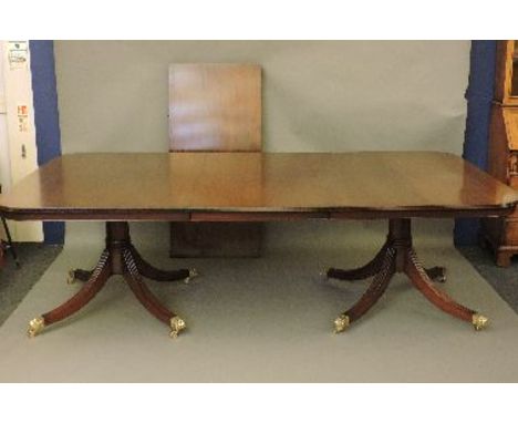 A mahogany dining suite, comprising a twin pedestal table, with two additional leaves, a set of ten Chippendale style dining 