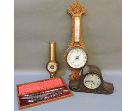 An oak cased aneroid barometer, another, a Westminster chiming mantel clock, and a three piece carving set