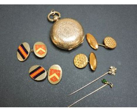 A rolled gold sovereign case, a gold and split pearl stick pin, a gold and jade stick pin, and costume cufflinks