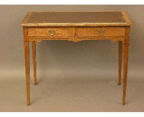An Edwardian oak writing table, 91.5cm wide, and an anglepoise lamp