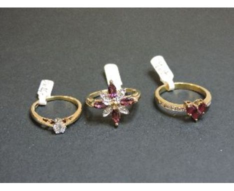 A 9ct gold heart shaped ruby cluster ring, with diamond set shoulders, a 9ct gold pink tourmaline and diamond star flower clu