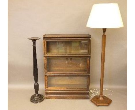 A Globe Wernicke bookcase, with three glass doors, 87cm wide, a torchère, and a standard lamp