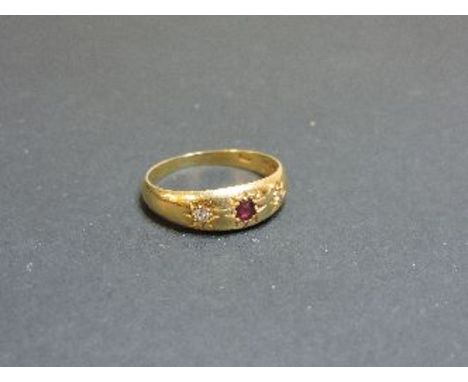 An Edwardian three stone ruby and diamond star set gypsy ring, hallmarked 18ct gold, Chester 1911, 4.3g approximately