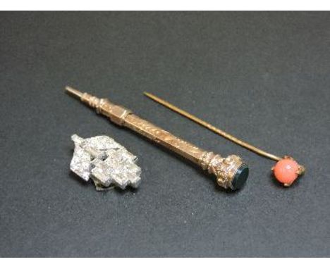 A gold slide action pencil, with a bloodstone set end, a paste brooch, and a stick pin