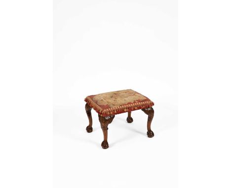 A Georgian style rectangular stool with a rectangular tapestry upholstered seat on carved cabriole legs with claw and ball fe