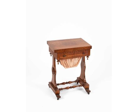 A Victorian rosewood games/sewing table, the lift up top enclosing a swivel chess, backgammon and cribbage board, with sewing