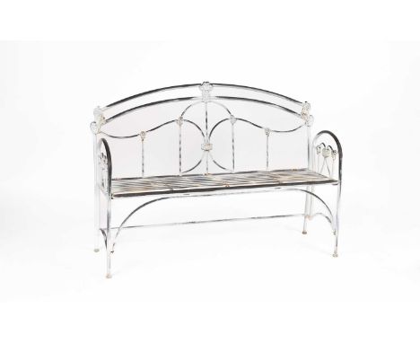 A metal garden bench of folding design, 20th Century, the arched back with scroll cast details, arched arms and a hinged slat