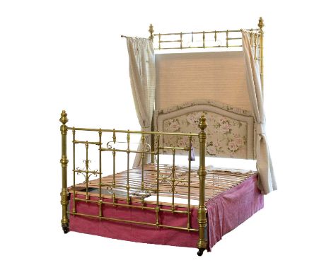 A late Victorian brass bed frame, with tall headboard posts fitted with brackets with associated hangings, with a brass footb