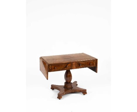 An early 19th Century figured walnut sofa table, raised on a square baluster column above a quadripartite base, 151cm wide (f