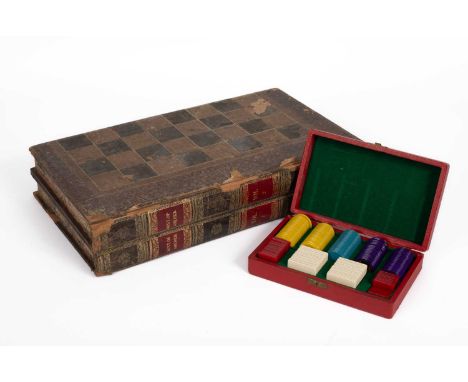 A leather chess/backgammon board of folding form, modelled as two volumes of History of America, with two dice shakers, sixte