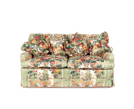 An upholstered two seater sofa by Portman Upholstery with a possibly later quilted Colefax and Fowler green chintz slipcover,