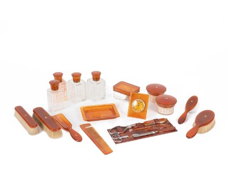 A French faux tortoiseshell dressing set, early 20th Century, with brass inlaid initials MC, including four brushes, a comb, 