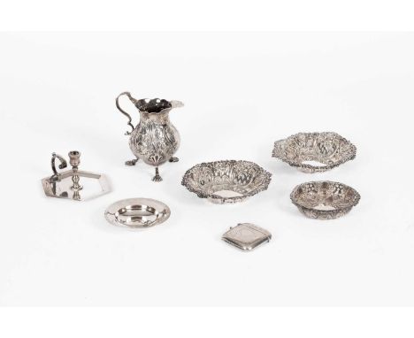 A quantity of silver and white metal to include three pierced dishes, a silver repousse jug, a hexagonal based candlestick, a