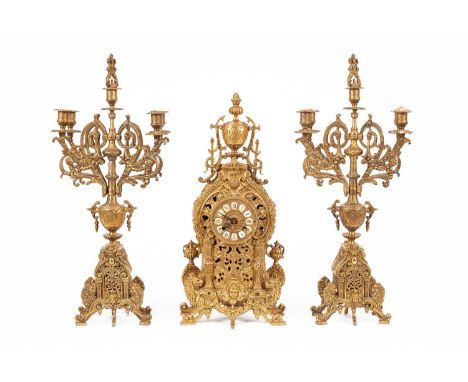 A late 20th Century brass mantel clock garniture, German ting-tang striking movement in a cast case, 56cm high, flanked by a 