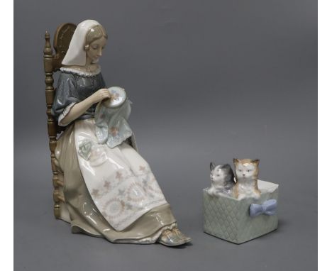 A Lladro figure of a lady sewing and a Nao group of kittens