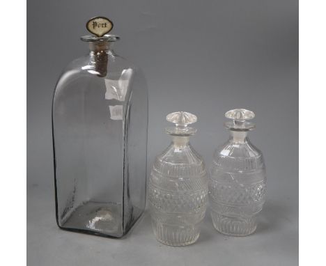 A tall early 19th century Dutch glass case decanter and a pair of cut glass barrel shaped spirit decantersCONDITION: Stopper 