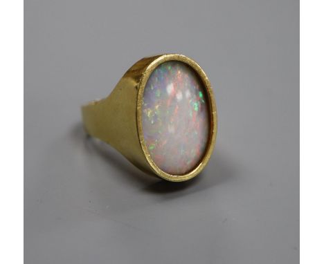 A modern 18ct gold and oval white opal set dress ring, size J, gross 8.4 grams.CONDITION: Stone measurements approx. 17.4mm b