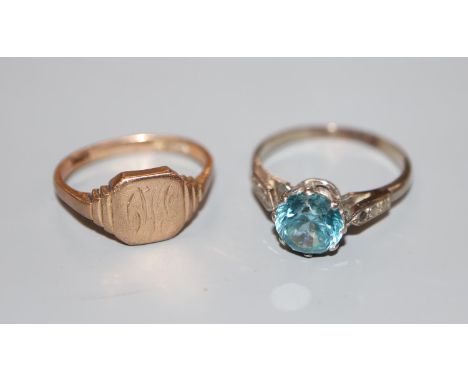 A 9ct gold signet ring(worn), 2.8 grams and a white metal and blue zircon(worn) dress ring, size N, gross 2.5 grams.