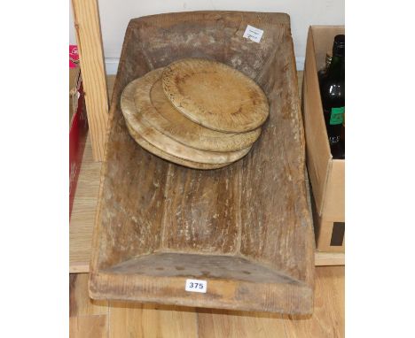 A Victorian wooden grain trough and four turned bread boards (5)