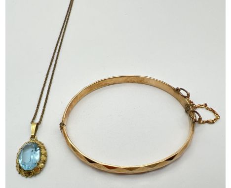 2 items of rolled gold jewellery. A 14ct rolled gold oval pendant set with a blue stone in a floral design mount, on an 18" f