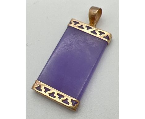 A lavender jade pendant with 9ct gold pierced work cap to top and bottom. Gold mark to inside of bale. Total length approx. 3