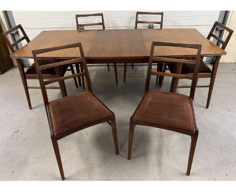 A mid century Afrormosia wood draw leaf extending dining table &amp; 6 chairs, by Richard Hornby for Heals. Table raised on t