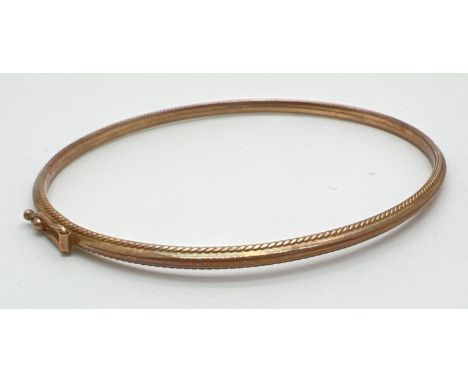 A thin 9ct gold bangle with bead decoration to edges. Push clasp with safety clip. Full hallmarks to clasp. Total weight appr