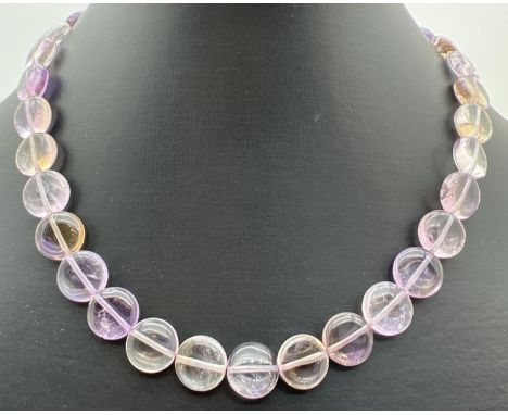 A 15" necklace made from flat circular Ametrine (a mixture of amethyst &amp; citrine) beads. With a silver tone S shaped clas