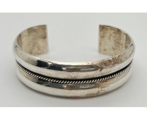 A 925 silver modern design cuff bangle with central rope style beading detail. Marked to inside of bangle, approx. 22.8g. 