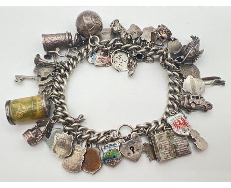 A vintage silver charm bracelet with padlock, safety chain and 43 silver &amp; white metal charms. Charm's include destinatio