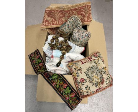 A large box of vintage textiles. To include tapestry panels, pom-pom tie backs, tapestry fronted cushions and handmade patchw