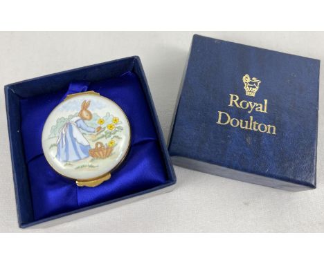 A boxed Royal Doulton Bunnykins circular enameled trinket box. Depicting a lady rabbit picking flowers. Vase of flowers detai