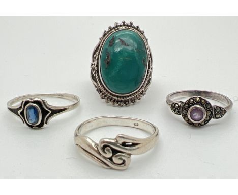 4 silver dress rings. To include turquoise set, amethyst set and Iolite set. Silver marks to inside of bands. To include size