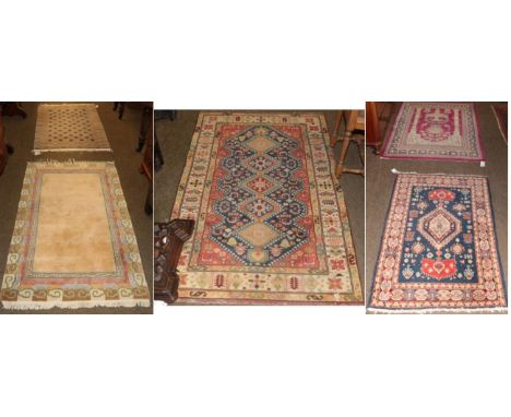 East Caucasian rug, the indigo field with stepped medallion framed by narrow borders, 127cm by 80cm, together with two other 