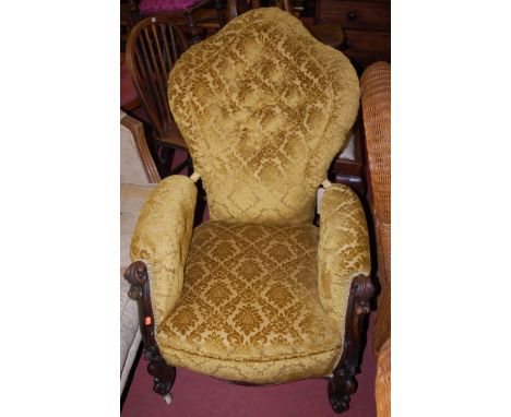 A Victorian carved mahogany framed and green floral button back upholstered armchair