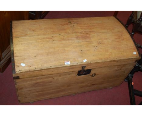 A pine and metal bound dome top travelling trunk with iron end carrying handles, width 90cm
