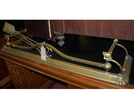A late Victorian brass fire fender, together with sundry fire tools (4)