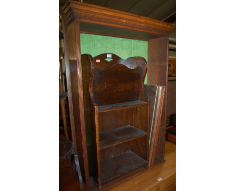 An Edwardian oak wall shelf; together with a 1930s oak freestanding magazine shelf (2) 