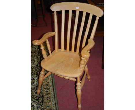 A set of twelve contemporary light elm slatback kitchen chairs, each having dished seats, to include pair of elbow examples (